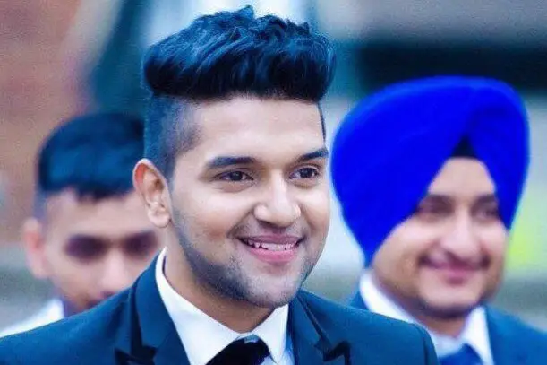 Guru Randhawa in a short length hair, flat top hair cut.