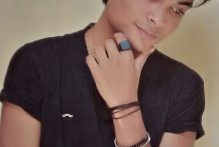 A boy wearing a black,square face ring