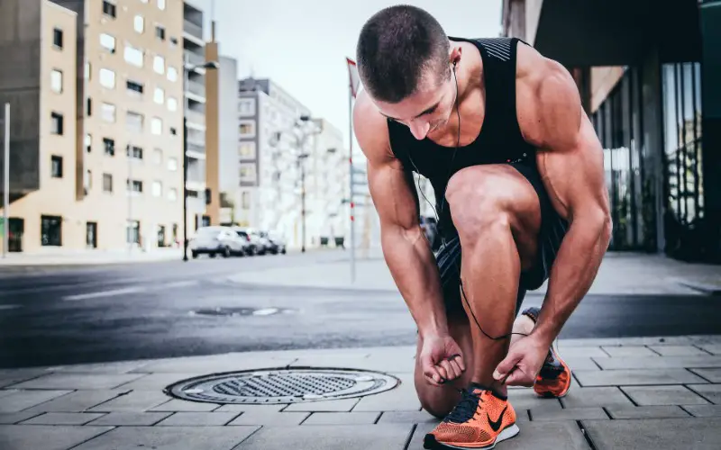 A man tieing his shoe's laces.