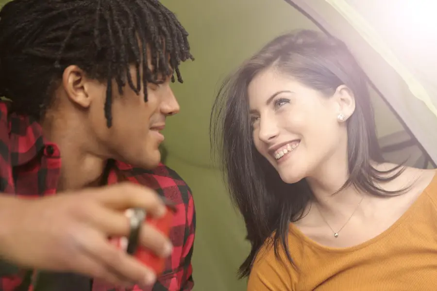 Guy is talking to a girl, drinking coffee.