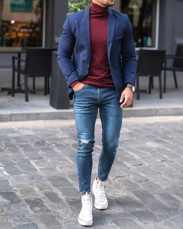 Men in Blue blazer and highneck with blue jeans.