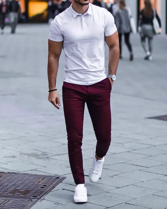 White polo tee and wine colour trousers.