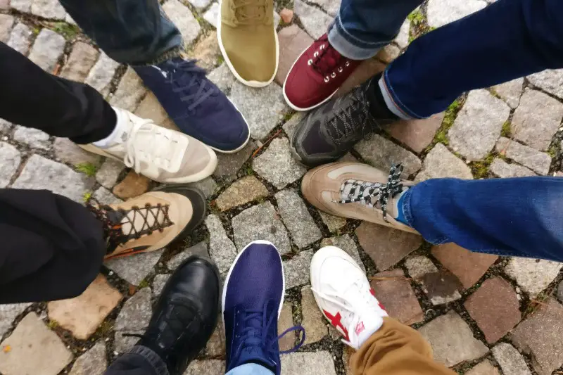 A group of guy's showing their shoes.