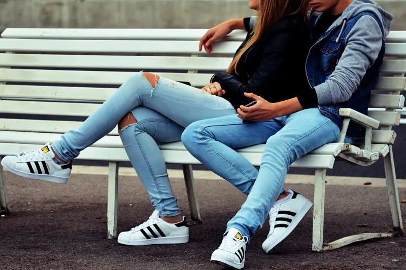 A girl and boy sitting outdoor.