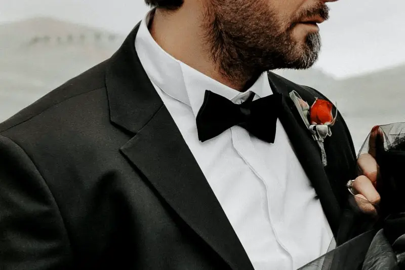 Man wearing tuxedo with Wing tip collar tuxedo shirt.