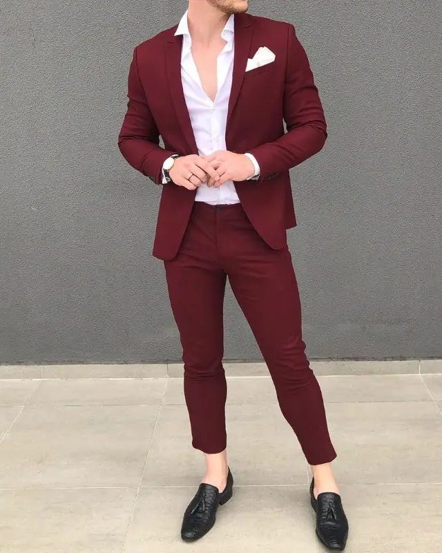 Man wearing maroon suit with white shirts