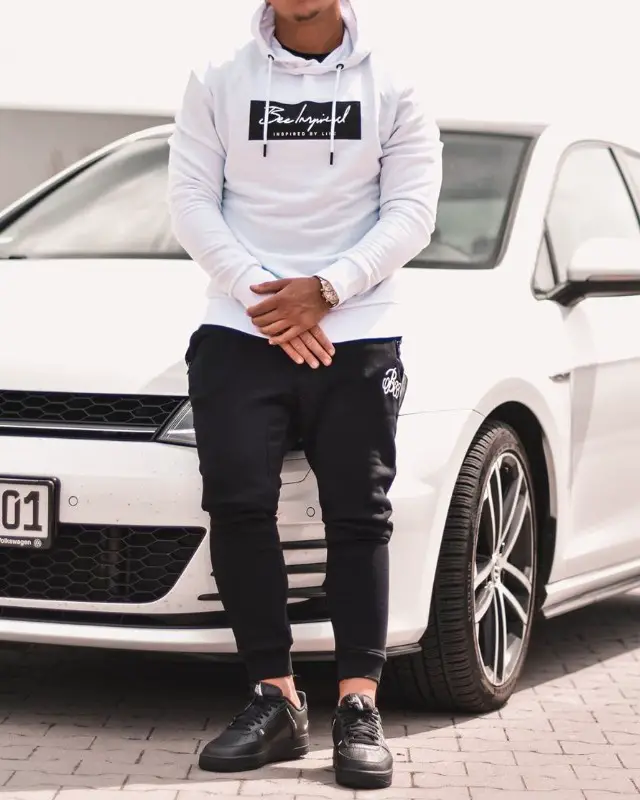 A man wearing Athleisure outfit, white hoodie and stretchable joggers.