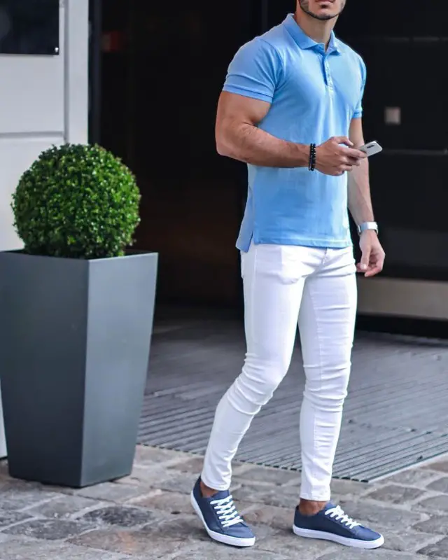 A man wearing skyblue polo shirt and white jeans.