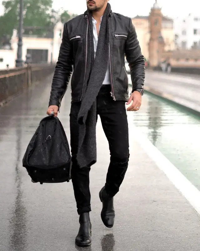 A man wearing Leather jackets+shirts+jeans + Chelsea boots+woolen muffler combinations outfit.