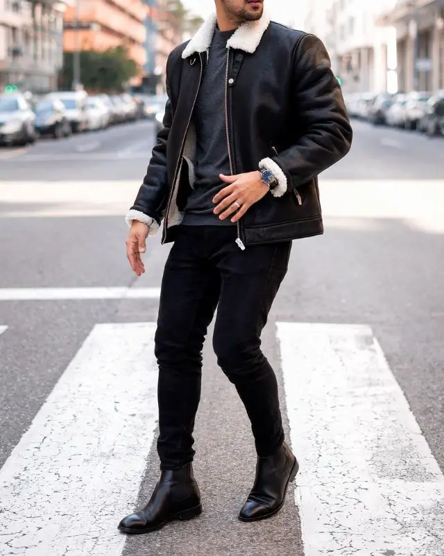 Man in Leather jacket, jeans, t-shirt and Chelsea boots.