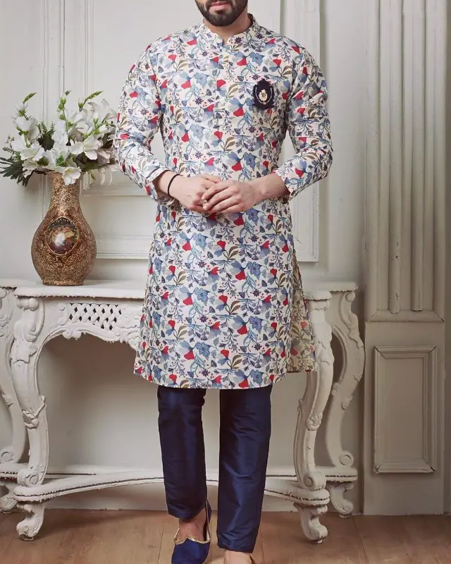 A man in floral print kurta-pyjama and jooti.