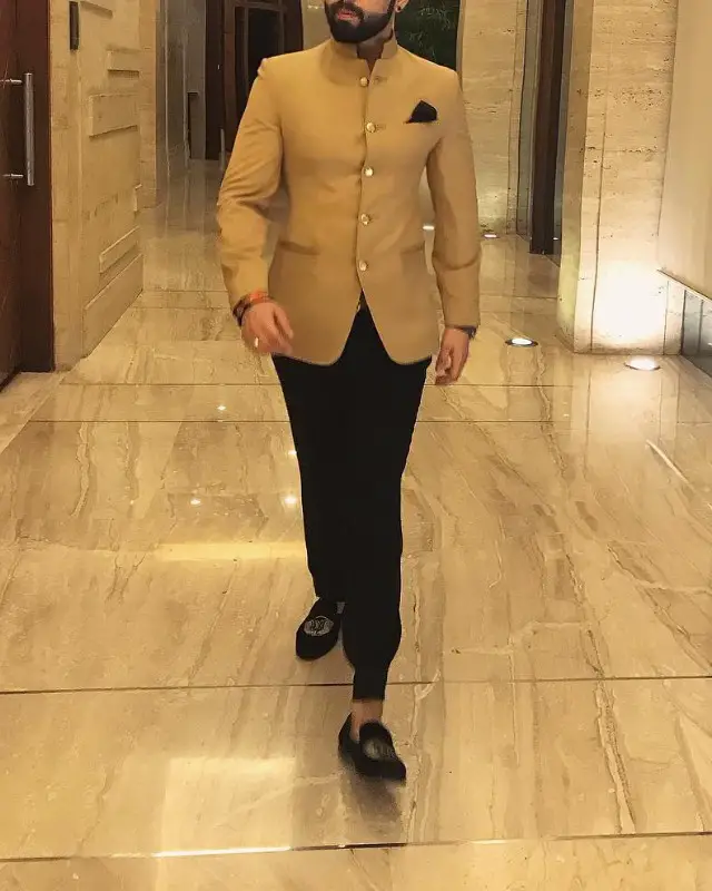 A man in trousers, slip-ons and Nehru jacket