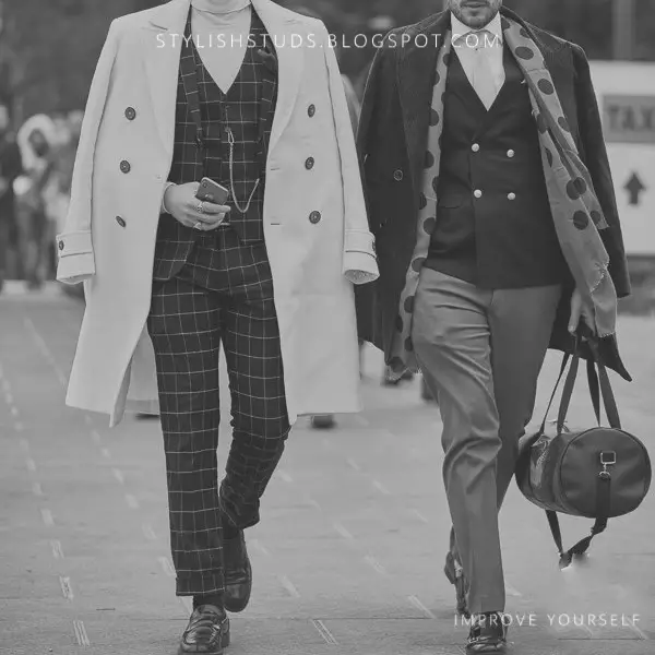 Two dandies are walking on a road