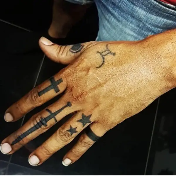 Cross tattoo on finger