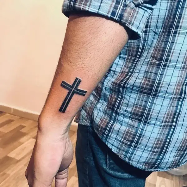 Small Cross tattoo on side wrist