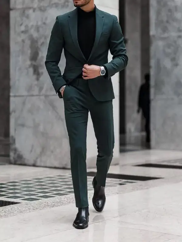 Teal colour suit with black turtleneck.