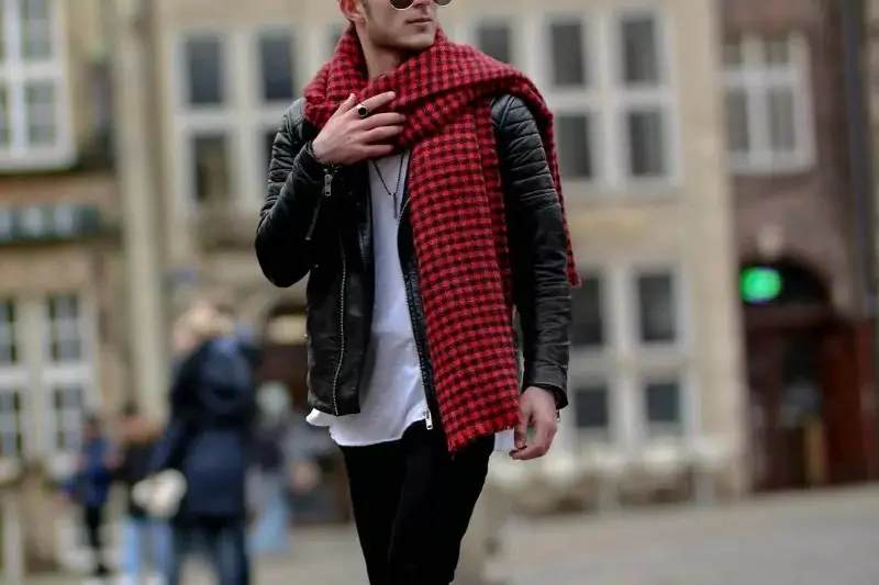 A man wearing a blanket scarf perfectly.