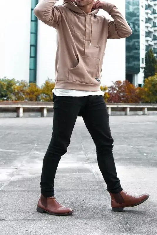 Beige hoodie and black jeans, men's outfit.
