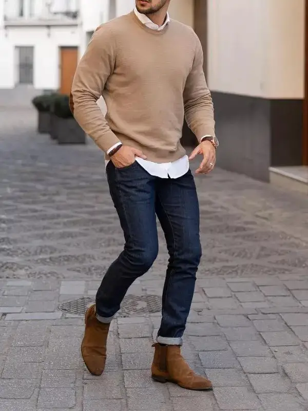 A man in sweater and jeans.