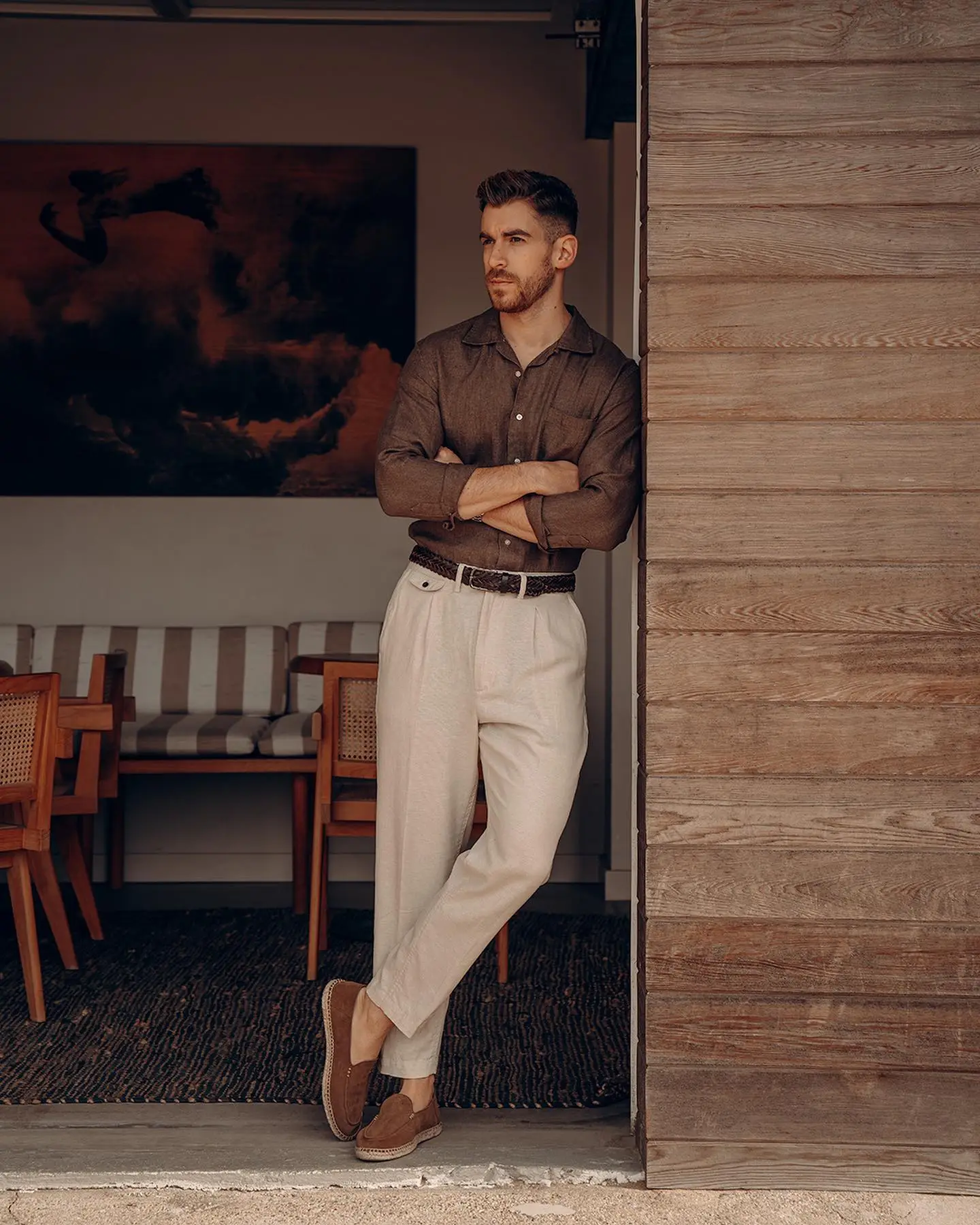 Fashionable Man In White Shirt And Beige Pants With Suspenders Sitting And  Posing On Wooden Ladder On Brick Wall Background Stock Photo  Download  Image Now  iStock